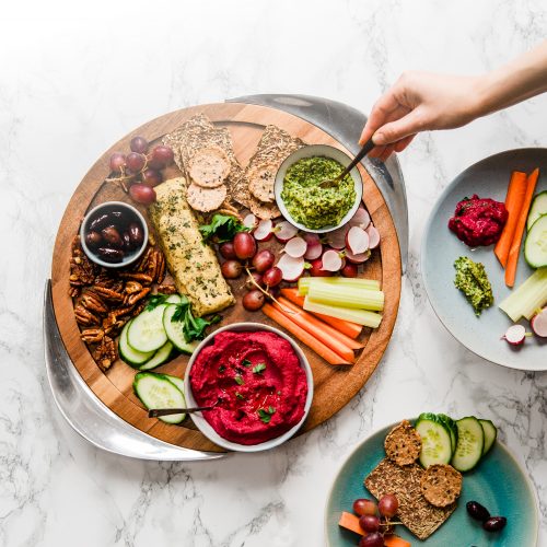 This is how to make and build a snack board or platter that's vegan and gluten free. Make radish hemp pesto, beet hummus, candied nuts and cashew cheese. Get all the recipes here.