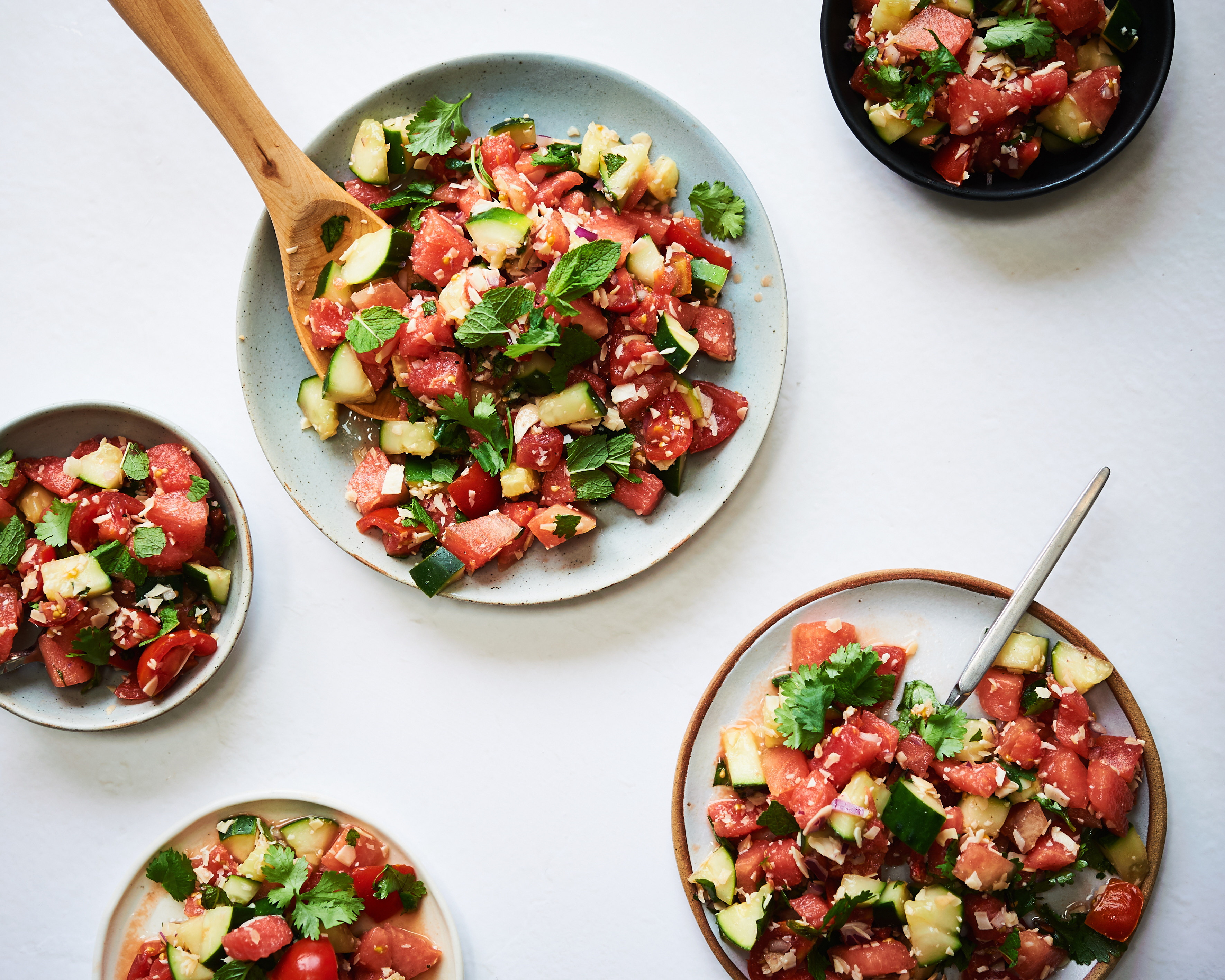 this watermelon salad is dairy free, vegan and gluten free. It's made with watermelon, cucumber, tomato, mint and fresh herbs and is a really delicious salad.