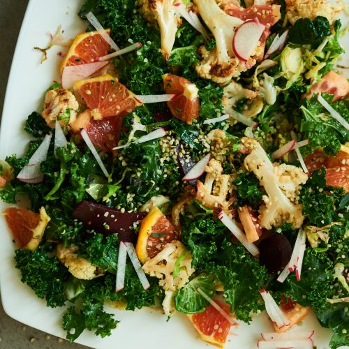 This is a recipe for a wilted kale winter salad with brussels sprouts, cauliflower, and beets.
